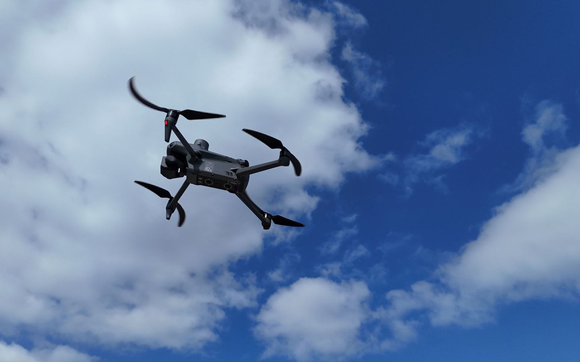 Drone in flight in slightly cloudy weather