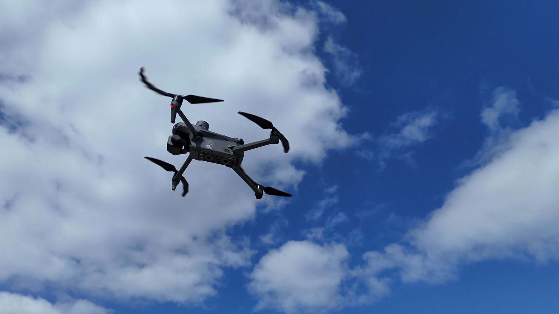 Drone in flight in slightly cloudy weather