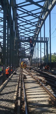 Signalbrücken werden in Köln auf einer Stahlbrücke von Mitarbeitern montiert.