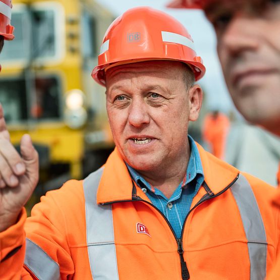 Mitarbeiter in Weste auf Baustelle